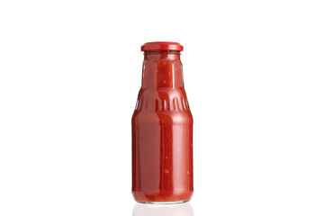 Glass bottle of ketchup isolated on white background.