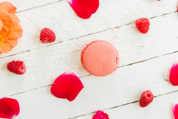 Red macarons on a white background with red flowers