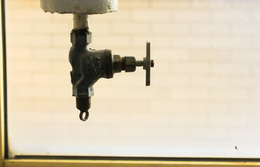 Plumbing valve and corpse close-up on a clean, warm background. Plumbing and plumbing systems.