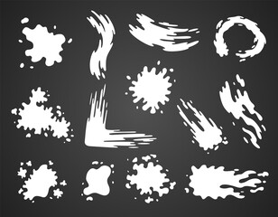 Paint blots. Splashes set for design use. Colorful grunge shapes collection. Dirty stains and silhouettes. White ink splashes on dark background