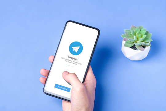 Melitopol, Ukraine - January 18 2021: Telegram application icon on smartphone screen. Online secure social media network. Blue background