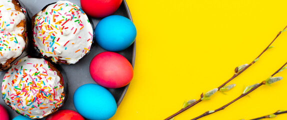 Fototapeta na wymiar Colored painted eggs on a yellow background. Easter banner. Festive banner with place for text. Religious holiday.