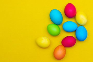 Fototapeta na wymiar Painted eggs on a yellow background. Chicken eggs on a yellow background. Chicken eggs are colored. Easter. Orthodox holiday. An article about Easter. Article about eggs benefits and harms. Copy space