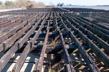 Skeletal remains of a wharf along the Mississippi River near Crescent Park in New Orleans, Louisiana, USA