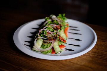Fresh tasty Greek salad on dark background