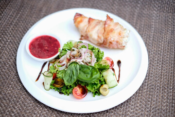 Chicken breast stuffed with cheese sauce and wrapped in pancetta bacon.