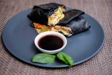 Black dough shawarma with french fries and sauce