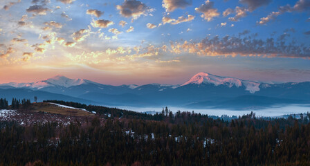 Early morning spring Carpathian mountains plateau landscape with snow-covered ridge tops in far, Ukraine.