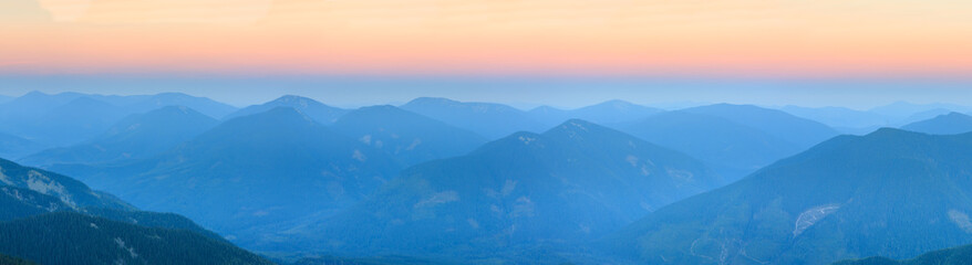 Fototapeta premium Mountain outline on morning sky background. Summer daybreak misty top view (Gorgany, Carpathians, Ukraine). 