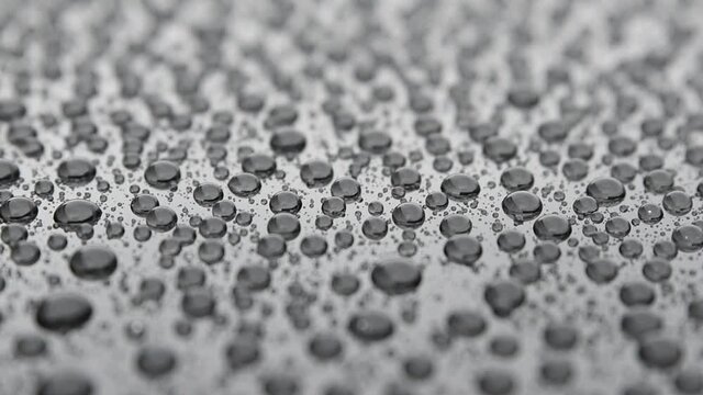 Water drops on car paint. Hydrophobic water effect on car body after using ceramic coating