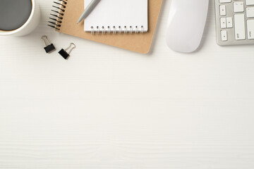 Flatlay view photo of office stationery kraft copybook pc accessories and cup of tea isolated white wooden backdrop