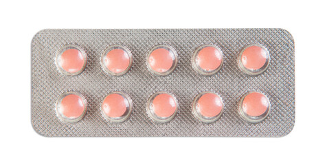 Pink medical pills in silver blister isolated against white background.