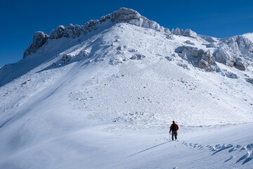 Naklejka na ściany i meble winter hiking sport at high peaks and peak success