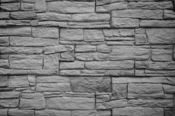 the background is made of old small, natural stones, in black and white shades