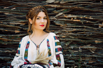 Beautiful young woman posing in romanian traditional costume.