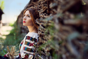 Beautiful young woman posing in romanian traditional costume.