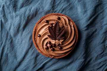 Chocolate Cannabis Tart with marijuana leaf. Delicious infused dessert cake for special occasion, valentines day treat, Christmas, thanksgiving.