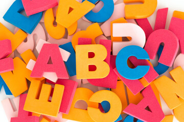 Fototapeta premium Background of multicolored stacked and messy letters