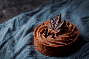 Chocolate Cannabis Tart with marijuana leaf. Delicious infused dessert cake for special occasion, valentines day treat, Christmas, thanksgiving.