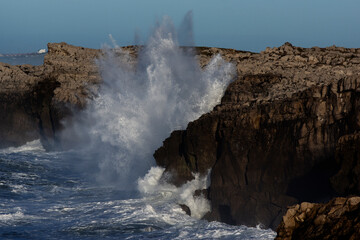 Huge waves hitting the cliff and exploding