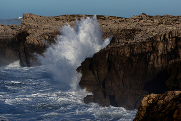 Huge waves hitting the cliff and exploding