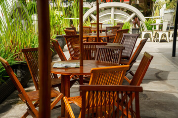 Fototapeta na wymiar Empty cafe with wooden chairs and table in Lembang Zoo, West Java, Indonesia.