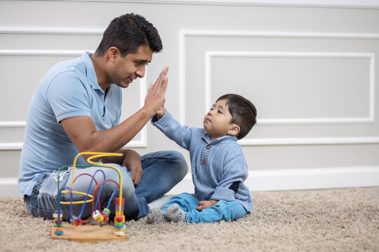 Mexican father and child doing high five