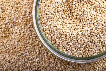 White quinoa background in a glass jar, closeup flat lay