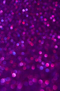 Abstract purple and pink dark glitter lights background. Circle blurred bokeh. Romantic backdrop for Valentines day, womens day, holiday or event