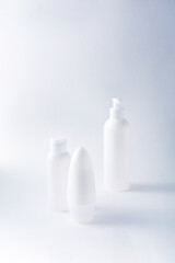 White bottles mockup for branding. Set of cosmetic products for cream, soup, deodorant, shampoo on light background. Tubes, dispensers and jars