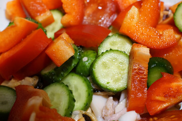 Green salad with tomatoes and cucumbers. Cabbage and red pepper.