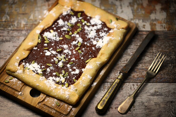 Soft focus. Homemade square galette with confiture.