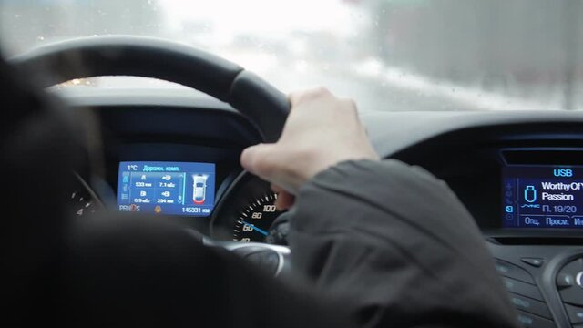 Turn signal of the car right on dashboard woman driving hand closeup