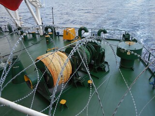 View of the ship side with razor wires fitted to stop pirates from boarding © Antony