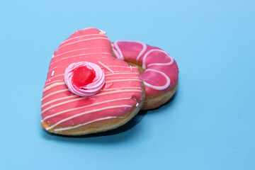 An assorted dozen donuts in a box isolated on a blue background