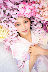 Obraz na płótnie Canvas Asian beautiful girl in flowers