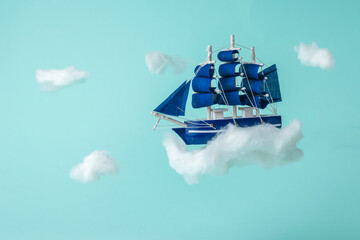 Installation of a sailboat flying through the sky between the clouds.