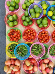 The vegetable shops in the market have tomatoes, lemons, paprika.All of them are organic products that are grown from the backyard of the villagers.Put it in a round basket for selling to the customer