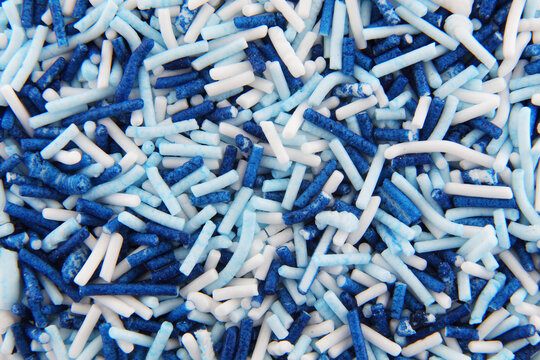 White and blue hundreds and thousands sprinkles sugar beads used for decorating cakes and desserts