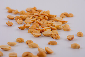 Fried and salted peanuts pile isolated on white background, Close-up