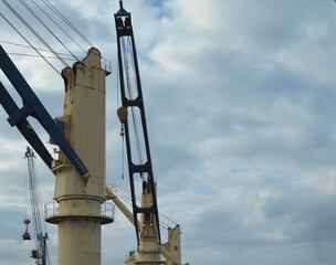 View of the deck cranes fitted onboard a merchant vessel, bulk carrier type vessel is at berth with...