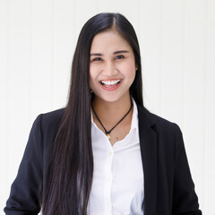 half body shot of young beautiful and happy Asian woman wearing smart casual smiling with friendly and happy face standing over white background. Confident businesswoman concept