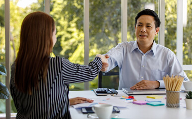 Group of business people wearing formal clothes sitting around working table. Congratulate for the success of the company business with a happy and cheerful expression