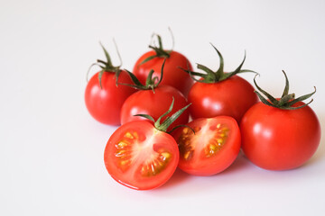 Whole and half Otento sweet diamond tomatoes or cherry tomatoes  isolated on white background.
