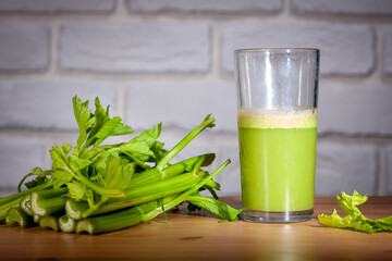 Healthy Celery diet for the treatment of incurable mysterious diseases. Fresh celery juice squeezed out on a juicer.drink, vegetable juice, studio shot