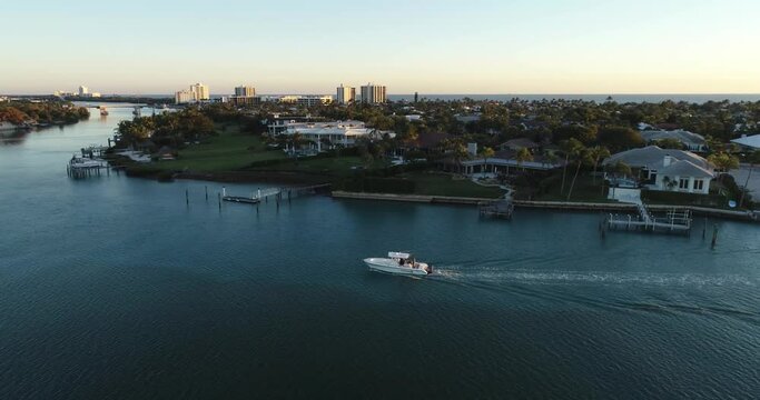 Boater Cruising Through Jupiter Inlet Colony After Coming In From The Sea.