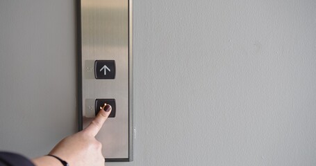 Close up person pushing on the button elevator