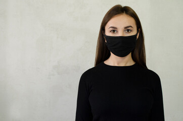 girl in a black medical mask on her face