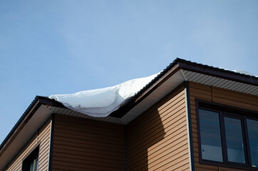 snow on the roof of the house