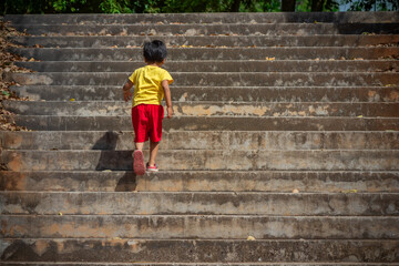 boy walking up the concrete stairs